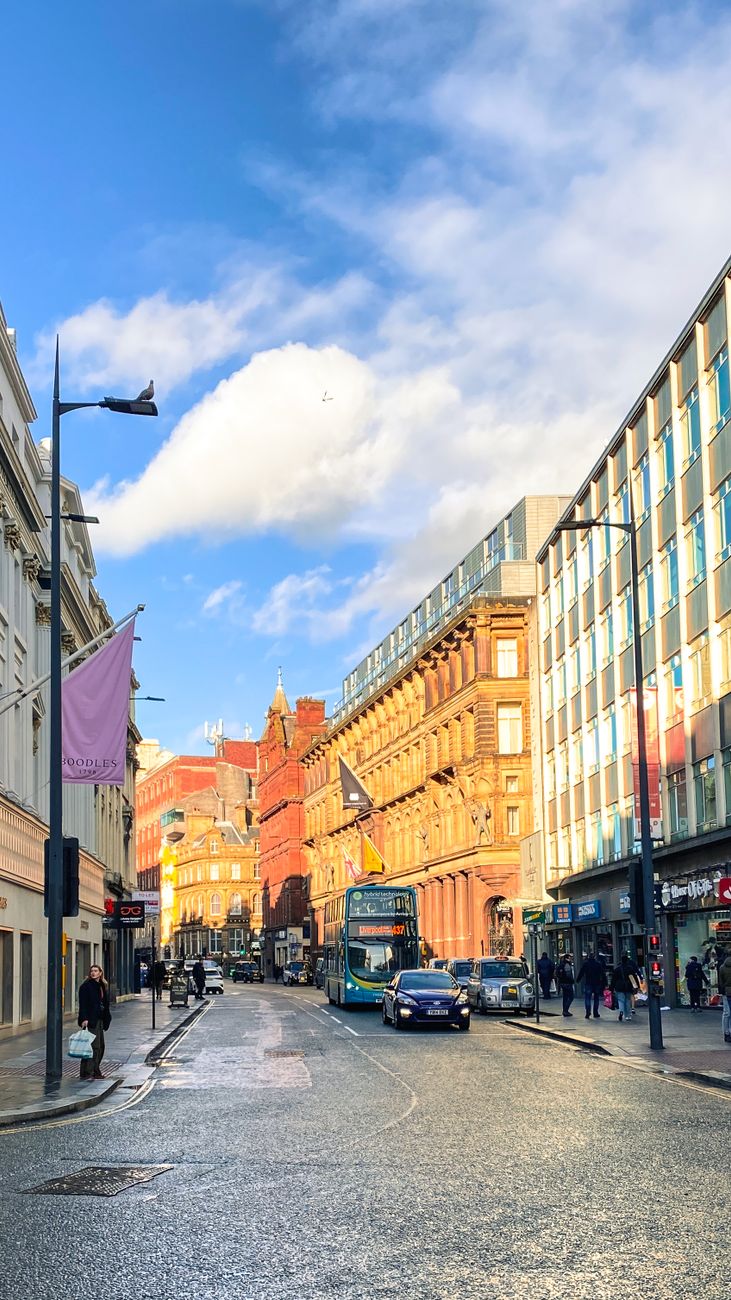 Liverpool city street with traffic and red-brick buildings